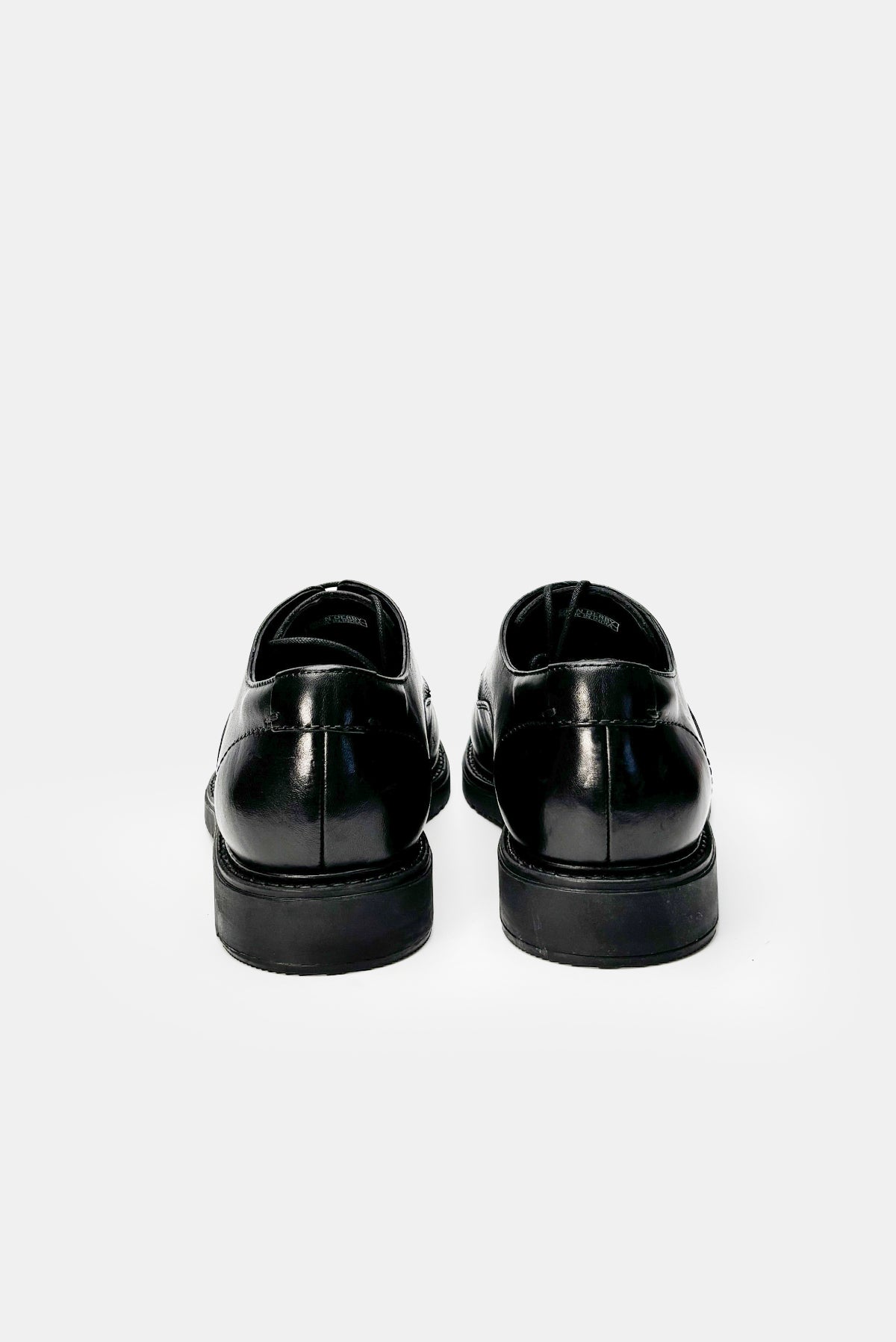 Black dress shoes on a white background