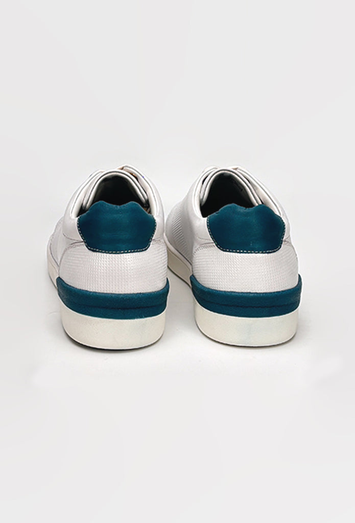 White sneakers with blue soles on a white background