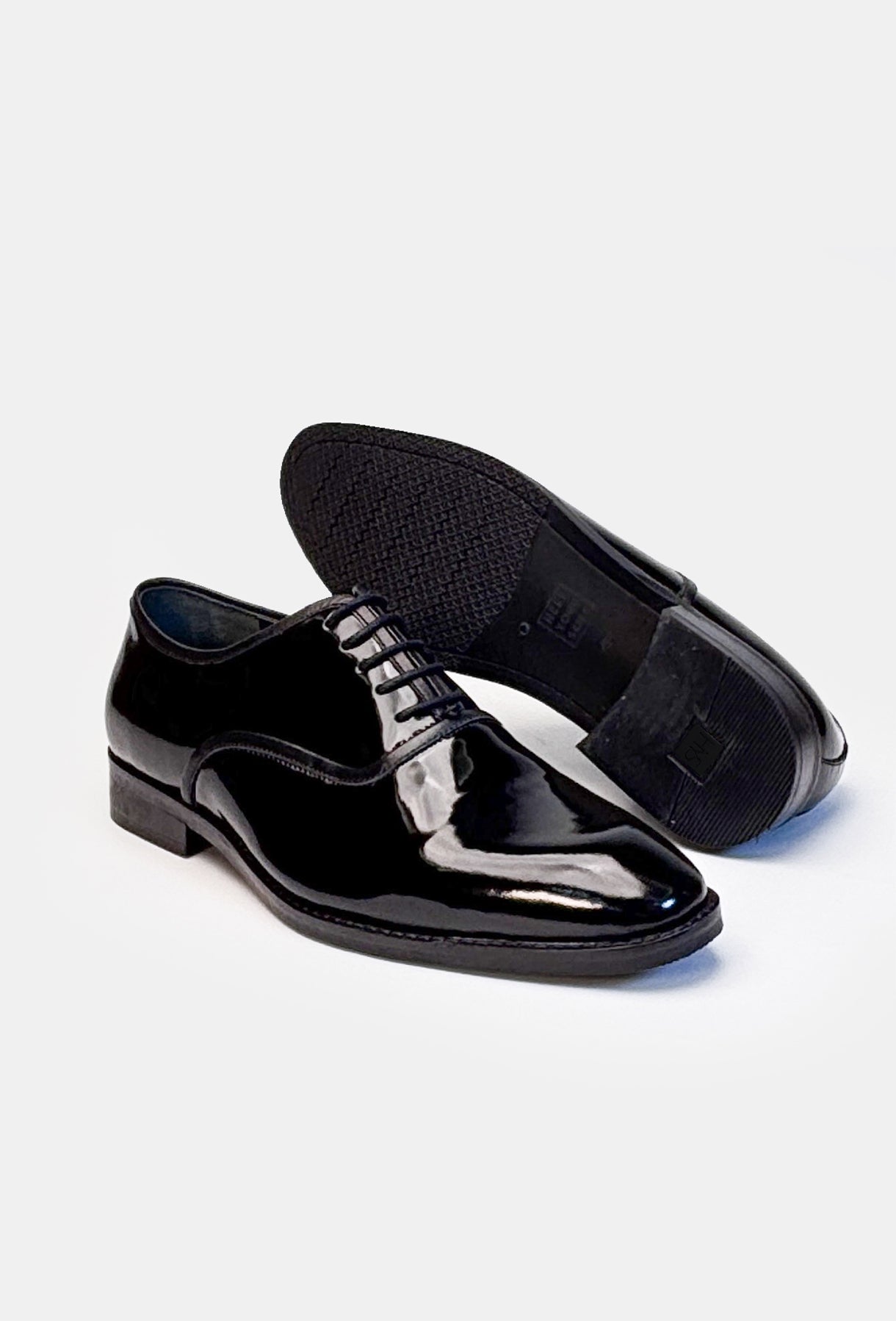 Pair of black dress shoes on a white background